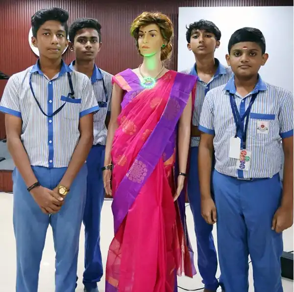 Iris, a humanoid robot teacher, standing with students of KTCT Higher Secondary School in Thiruvananthapuram, Kerala