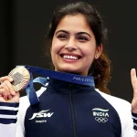 Manu Bhaker holding up her Olympics 2024 medal and making the victory sign