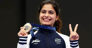 Manu Bhaker holding up her Olympics 2024 medal and making the victory sign