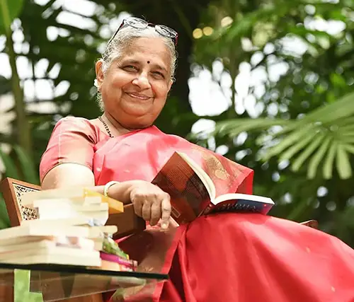 Sudha Murty sitting with an open book on her lap