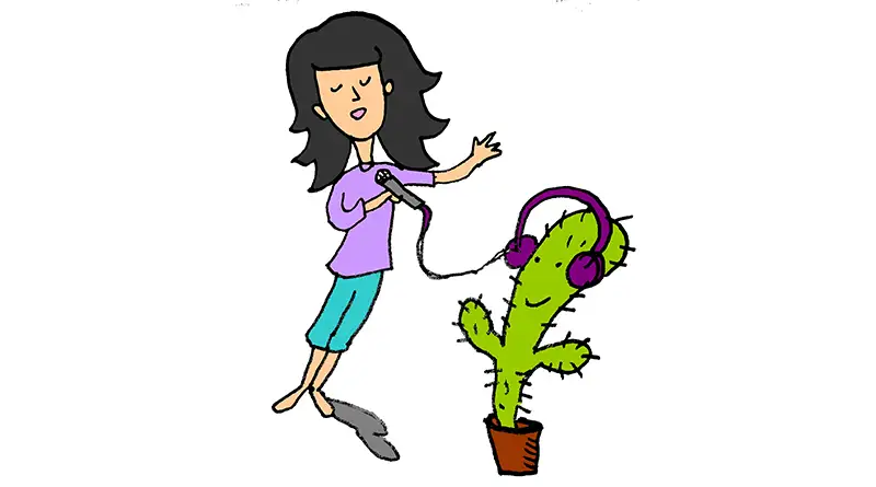 Young girl dancing with a cactus wearing headphones
